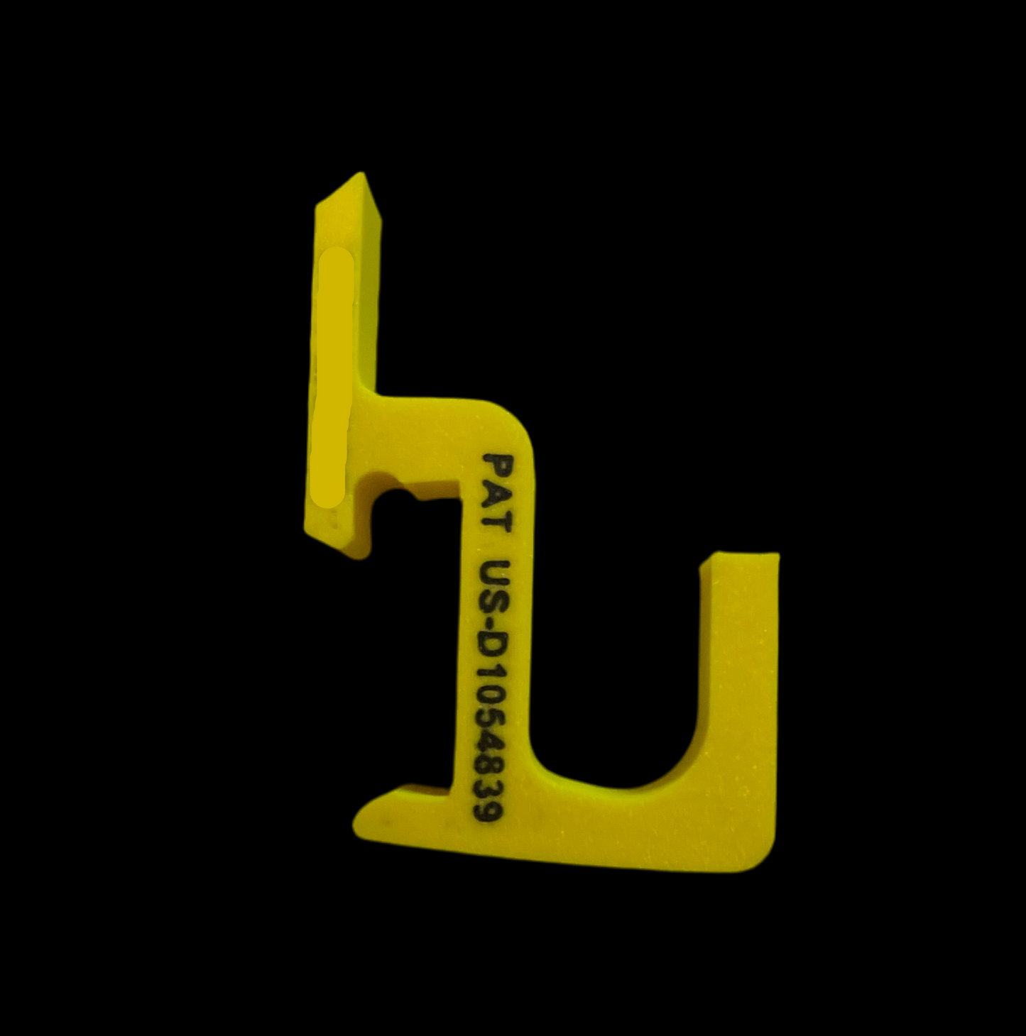 Yellow plastic tool with text on a black background
