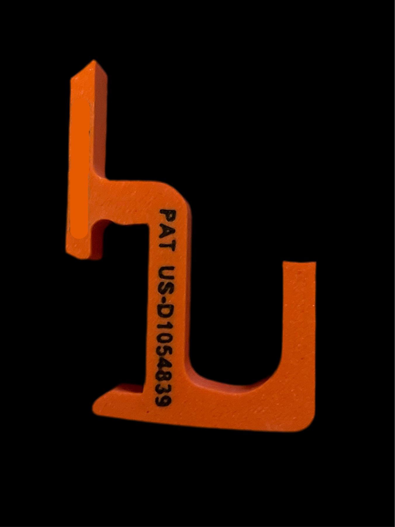 Orange U-shaped tool with text on a black background