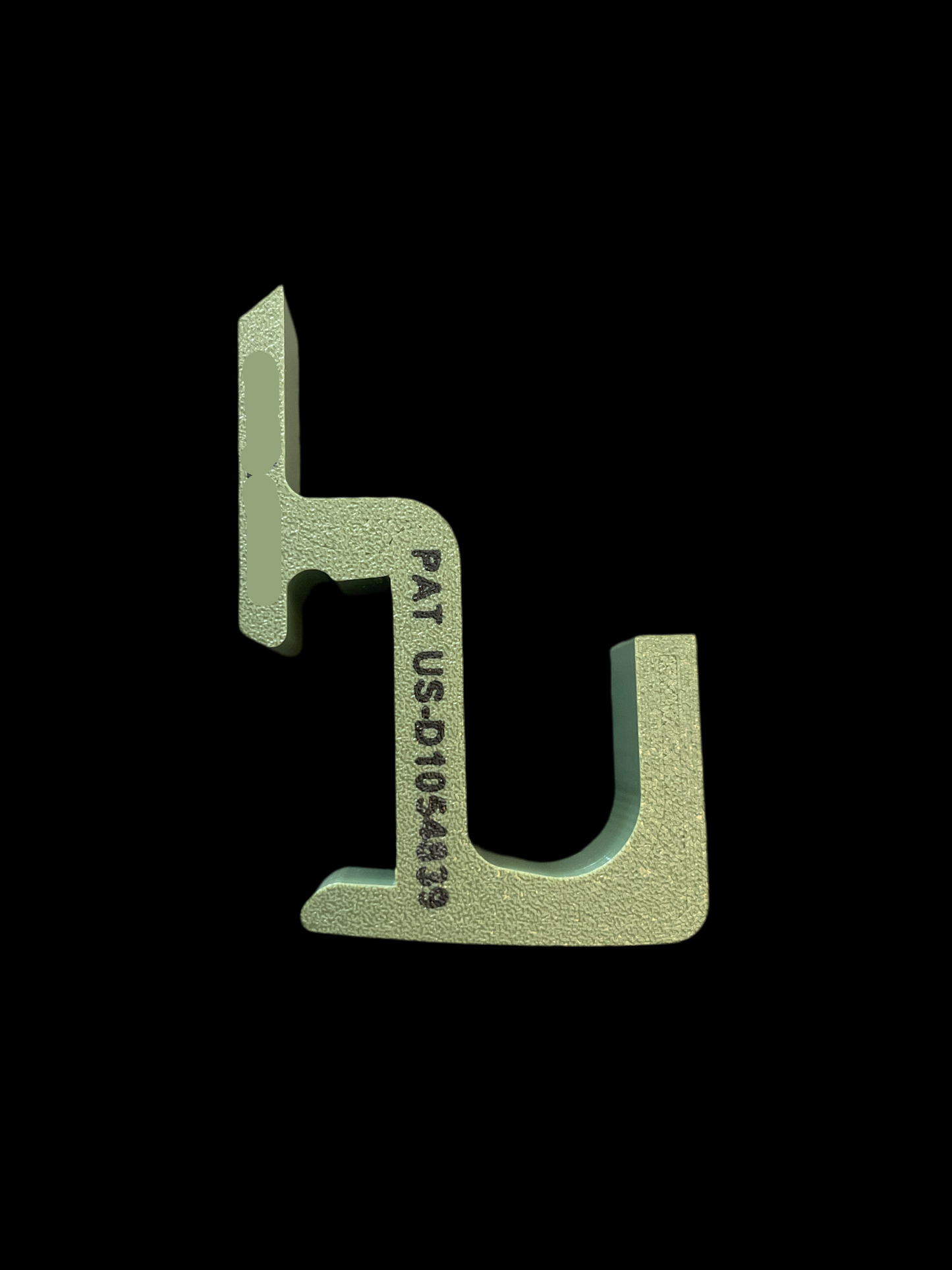 Metallic green tool with text on a black background